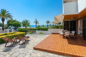 a patio with chairs and a table on a house at Apartment La Bugambilia in Port de Pollensa