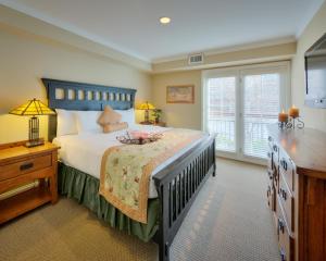 a bedroom with a large bed and a window at Lantern Lodge in Asheville +19 photos
