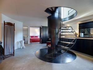 a spiral staircase in the middle of a room at A304 Romantic SeaShip in top Center in Amsterdam