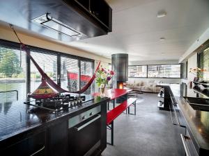 a kitchen with a red counter top in a room at A304 Romantic SeaShip in top Center in Amsterdam