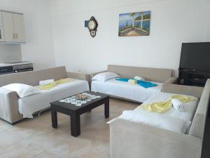 a living room with two couches and a coffee table at Grand Seaview Apartments in Ksamil