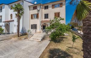 a large white house with palm trees in front of it at Apartments Magdalena AS1 in Rovinj