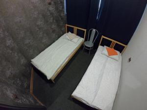 an overhead view of two beds and a chair in a room at Hostel Kirovsk.red in Kirovsk