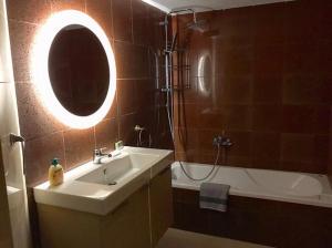 a bathroom with a sink and a shower and a mirror at La Vatura in Gialova