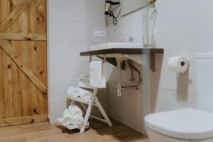 a bathroom with a sink and a toilet at Portales de Pizarro in Béjar +97 photos