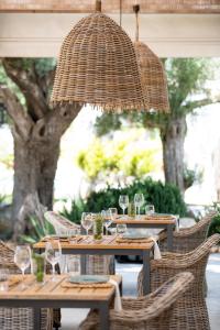 a dining room table with chairs and umbrellas at Can Arabí in Ibiza Town