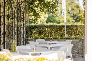a row of tables and chairs on a patio at Boutiquehotel Caravella Velden by S4Y in Velden am Wörthersee +94 photos