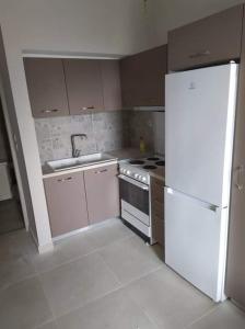 ペタリディオンにあるPetalidi Fragkosのキッチン(白い家電製品、白い冷蔵庫付)