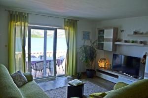 Il comprend un salon doté d'une télévision et d'un balcon. dans l'établissement Apartments Rina - Kneže, à Račišće