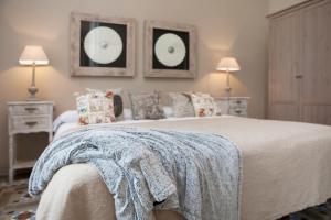 a bedroom with two beds and two mirrors on the wall at BCN Rambla Catalunya Apartments in Barcelona