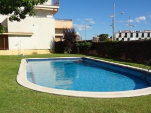 a swimming pool in the yard of a building at Atico Duplex Coral in Sitges