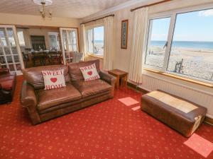 a living room with a leather couch and a table at The Pirate in Narberth