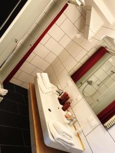 a bathroom with a white sink and a mirror at Hotel Krumbach in Krumbach