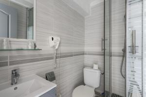 a bathroom with a toilet and a sink and a shower at Hotel Les Palmiers En Camargue in Saintes-Maries-de-la-Mer