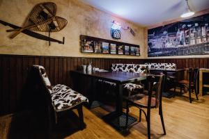 a dining room with a table and chairs and a bar at Road Stop Dortmund in Dortmund