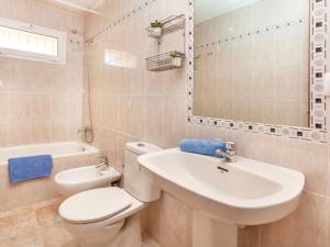 a bathroom with a white toilet and a sink at Apartment Villa Cordoba-1 by Interhome in Port de la Selva +3 photos