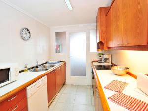 a kitchen with a sink and a clock on the wall at Apartment Sorolla-1 by Interhome in Jávea
