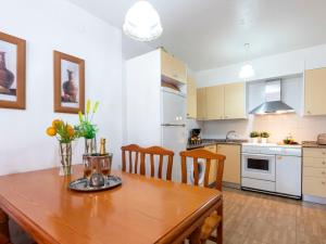 a kitchen and dining room with a wooden table and chairs at Holiday Home Coquetó by Interhome in Riumar +18 photos