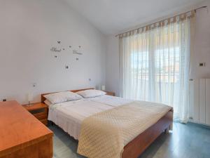 a bedroom with a large bed and a window at Apartment Adria by Interhome in Marčana