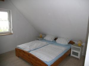 a small bed in a room with a window at Ferienhaus Kettler I in Muhr amSee