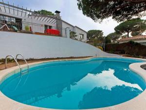 a swimming pool in front of a house at Holiday Home Ginesteres by Interhome in Argentona