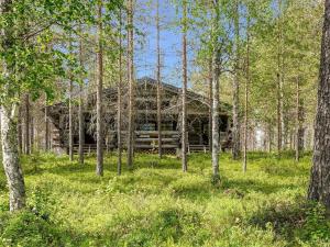 an old log cabin in the middle of a forest at Holiday Home Kulpakko 3 by Interhome in Tiainen
