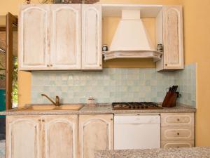 a kitchen with white cabinets and a sink at Holiday Home Emi by Interhome in Massa Lubrense +38 photos