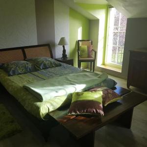 Llit o llits en una habitació de Le Logis de la Pataudière