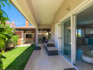 a patio of a house with a yard at Holiday Home Villa Valentina by Interhome in Loborika