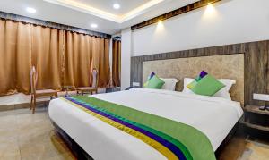 a bedroom with a large white bed with a rainbow at Hotel Bikalal, Bikaner in Bikaner
