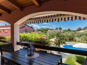 a patio with a table and a view of a pool at Apartment Koštro-1 by Interhome in Nova Vas