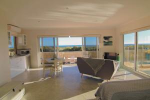 a kitchen and living room with a table and chairs at Ocean Reef Vista in Perth