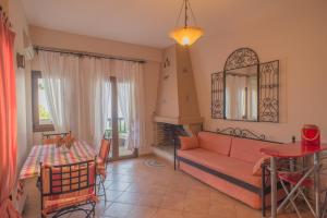 a living room with a couch and a table at Althea Archontika Tis Androu in Batsi