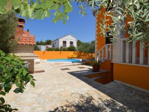 a backyard with a pool and a house at Holiday Home Gorana - BRC152 by Interhome in Mirce