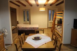 a dining room with a table and a bunk bed at Casa Cisa in Muggia