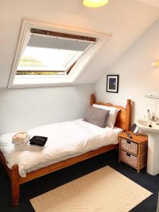 a bedroom with a bed with a window and a sink at EveAnna in Alnwick