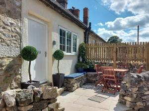 a patio with a table and chairs and a house at Royal Oak in Matlock