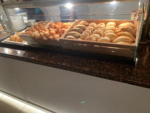 a display case with many different types of donuts at Aparthotel Los Dragos del Sur in Puerto de Santiago