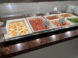 a buffet line with different types of breakfast foods at Aparthotel Los Dragos del Sur in Puerto de Santiago