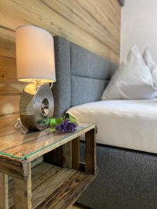 Nußdorf的住宿－Ferienwohnung Dolomiten，一间卧室配有一张床和一张带台灯的桌子