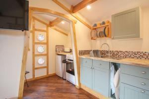 
a kitchen with a stove top oven and a sink at Kessenyans Studio in Perranporth
