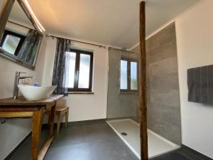 a bathroom with a sink and a bath tub at Ferienwohnung Dolomiten in Nußdorf