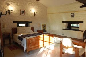 a bedroom with a bed in a room at Studio Gîte de Fontclairet in Champagne-Mouton