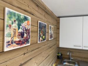 a kitchen with three pictures hanging on a wall at Ferienwohnung Dolomiten in Nußdorf