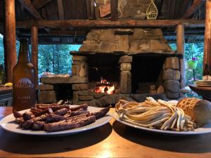 two plates of food on a table with a fireplace at Rysiówka in Poronin