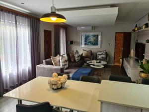 a living room with a table and a couch at Villa Casa Lifestyle in Nelspruit