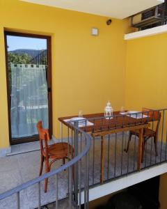 a dining room with a table and chairs and a window at Casa Vecchia, ma Moderna in Villar Perosa