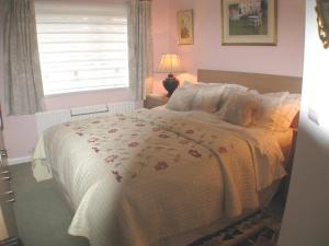 a bedroom with a large bed with a window at The Lantern in Donaghadee