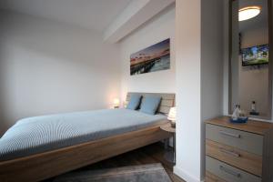 Ein Bett oder Betten in einem Zimmer der Unterkunft Meersinfonie Binzprora by Rujana