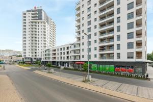 an empty street in a city with tall buildings at Chill Mood by Baltica Apartments in Gdańsk